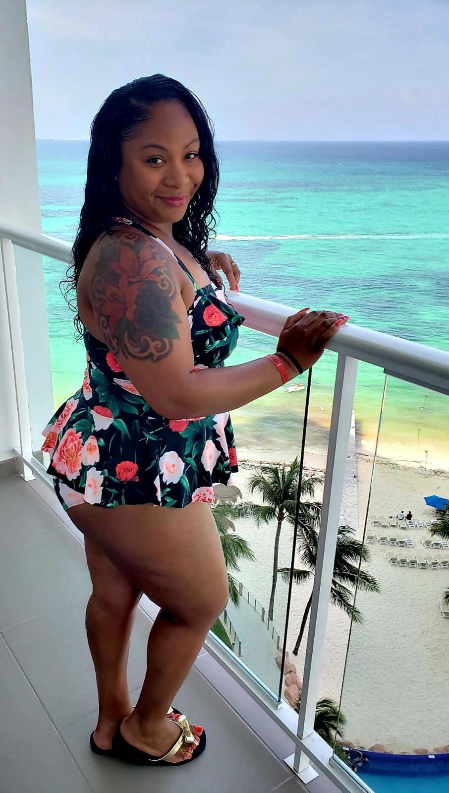 Reviewer wearing the floral black swimsuit