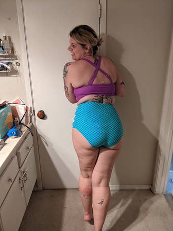 Reviewer wearing the mermaid two-piece shown from the back, where the top has crisscross straps