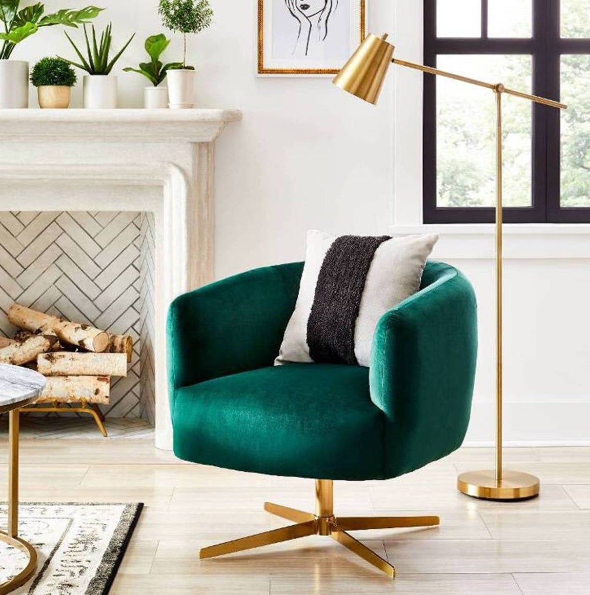 brass cantilever floor lamp next to a green arm chair