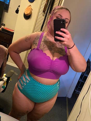 Reviewer wearing the bikini with a purple top and teal strappy scale print bottoms