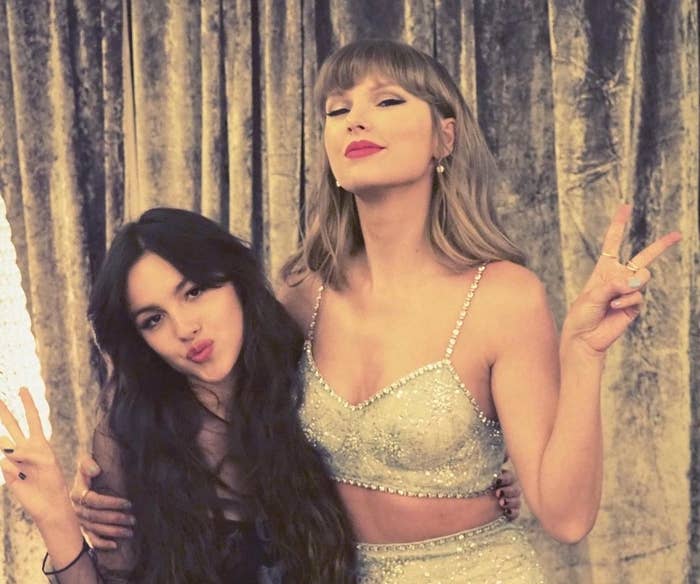 Olivia Rodrigo and Taylor Swift hugging and holding up peace signs