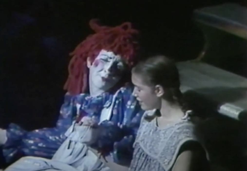 Raggedy Ann talking to a little girl