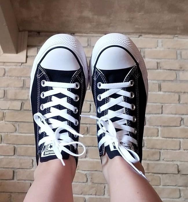 a reviewer in black and white converse