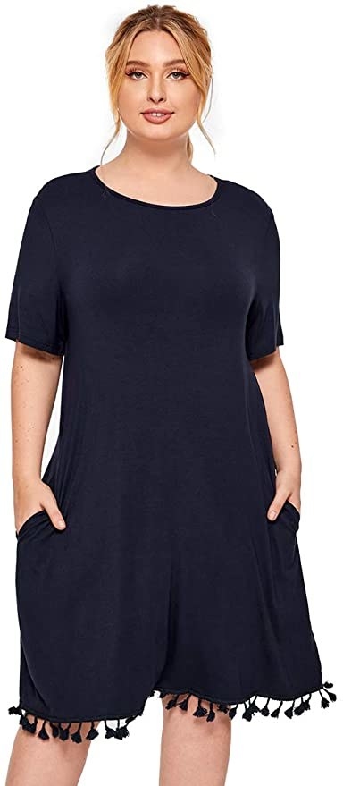 model in T-shirt dress with tassel trim along bottom