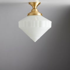 Diamond shaped flush mount light connected to ceiling with decorative gold base 