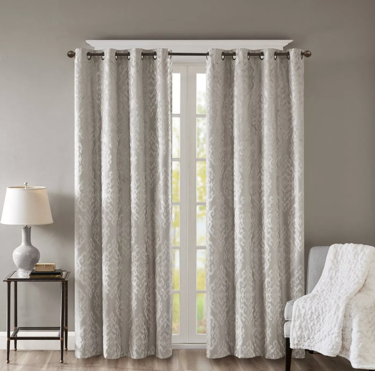 a set of gray and white jacquard print blackout curtains in a room