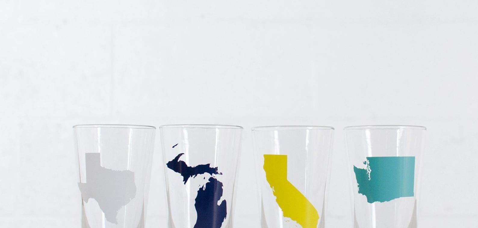 clear pint glasses with illustration of texas, michigan, florida, and washington on them