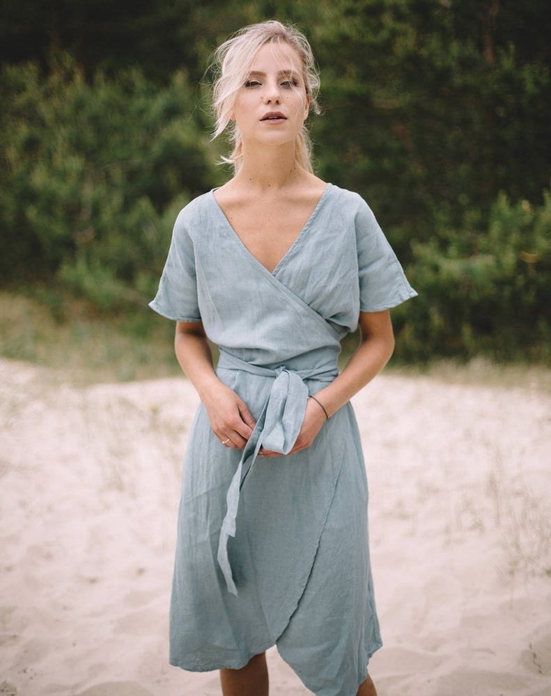 model wearing the short-sleeved wrap dress in light blue