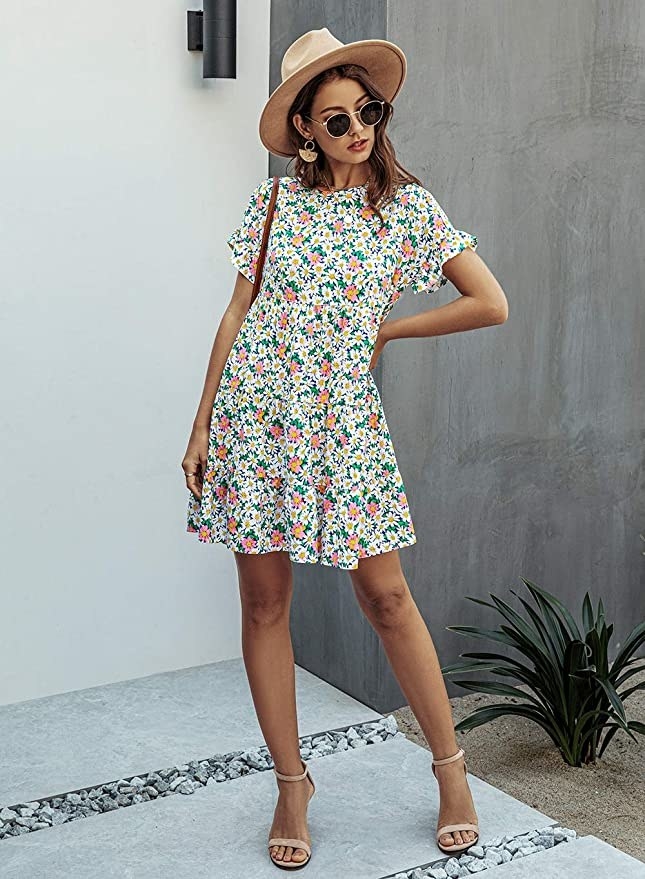 model wearing short sleeve floral dress with strappy sandals