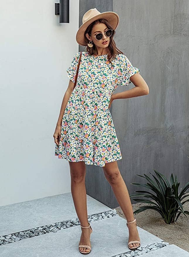 model wearing short sleeve floral dress with strappy sandals