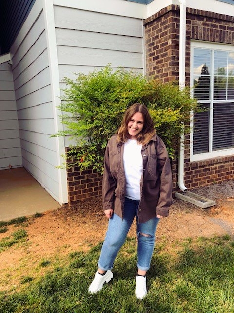 woman outside wearing jeans, white shirt and shoes, and denim jacket