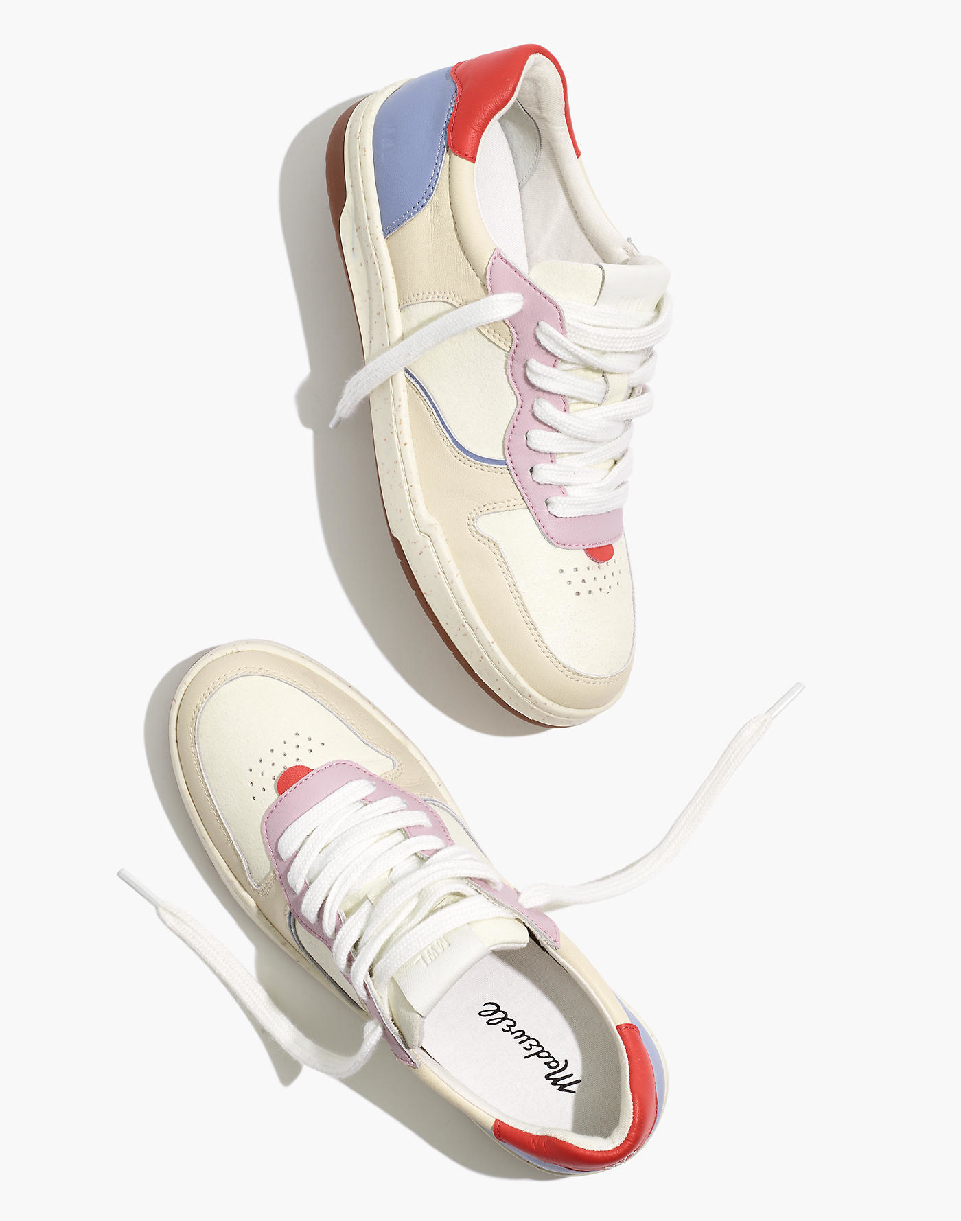 off white sneakers with pops of lilac, red, and blue color throuhgout 