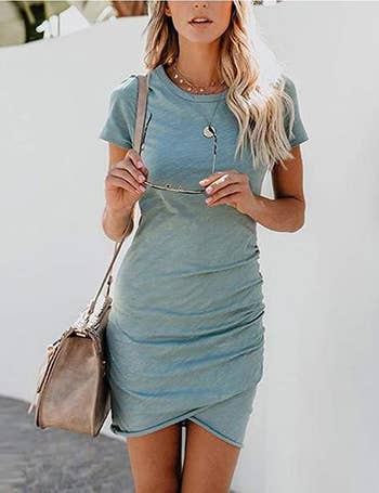 model wearing t-shirt dress styled with necklaces and shoulder bag