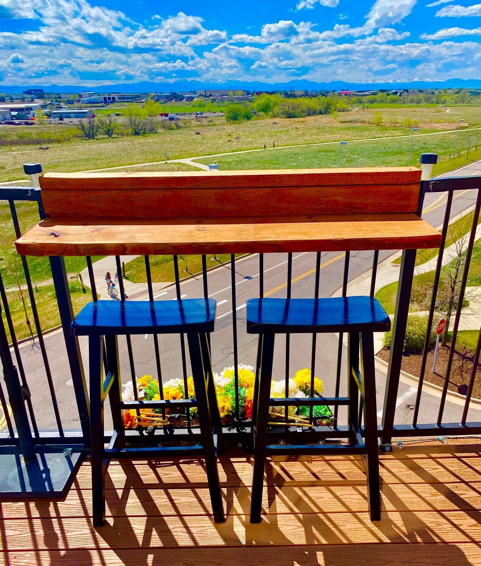 The wood bar attached to balcony railing