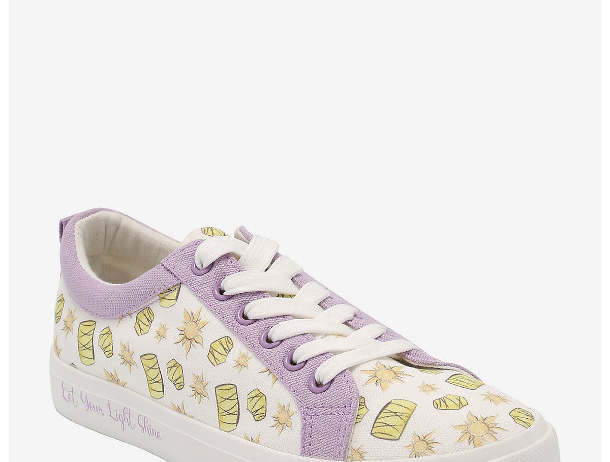 a qhite lace-up sneaker with lanterns and suns printed on it and lavender accents