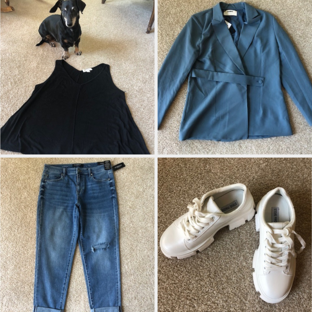 A black tank and dog, a blue jacket, jeans, and sneakers 