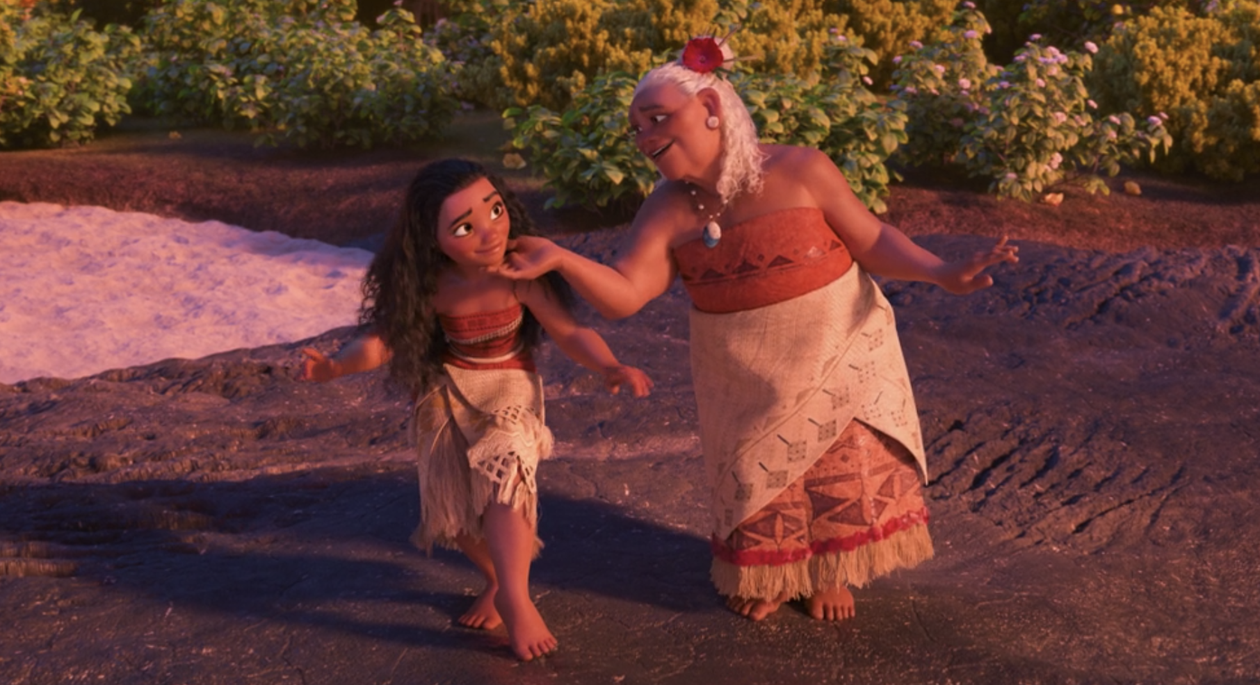 Moana dancing with her grandma, who is touching Moana&#x27;s chin