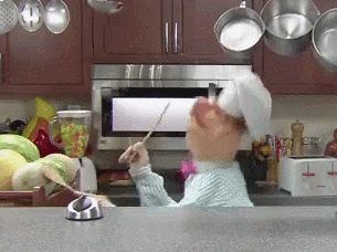 the Swedish chef puppet banging wooden spoons against some melons