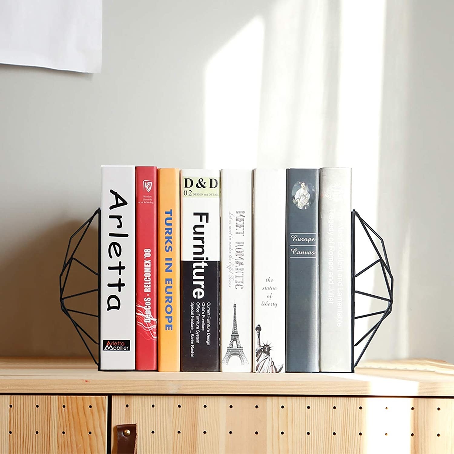 the geometric bookends holding a set of books together