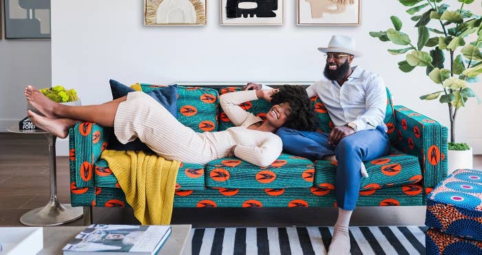 a velvet couch with a teal and orange print