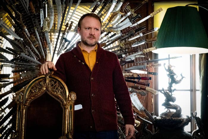 Rian standing by a chair adorned with a halo of knives