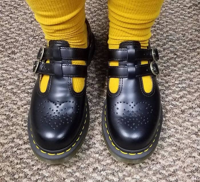 A reviewer models the shoes with yellow socks.