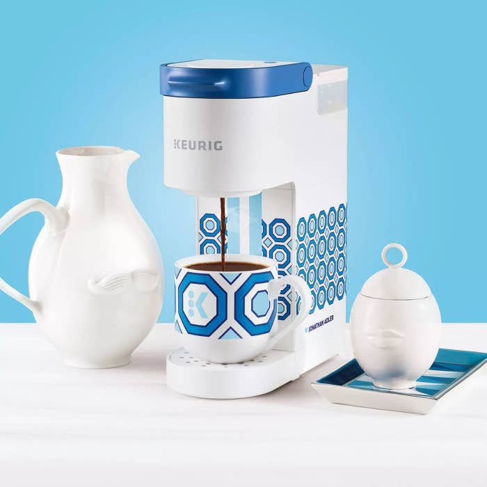 the patterned coffee maker next to white ceramics
