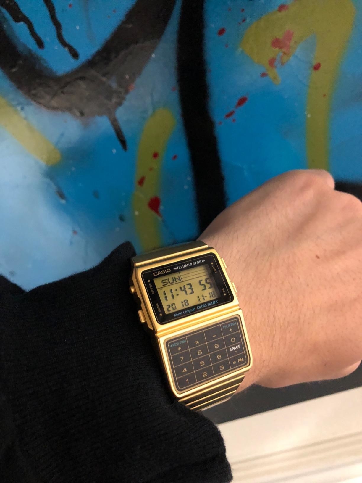 A reviewer wears the gold watch
