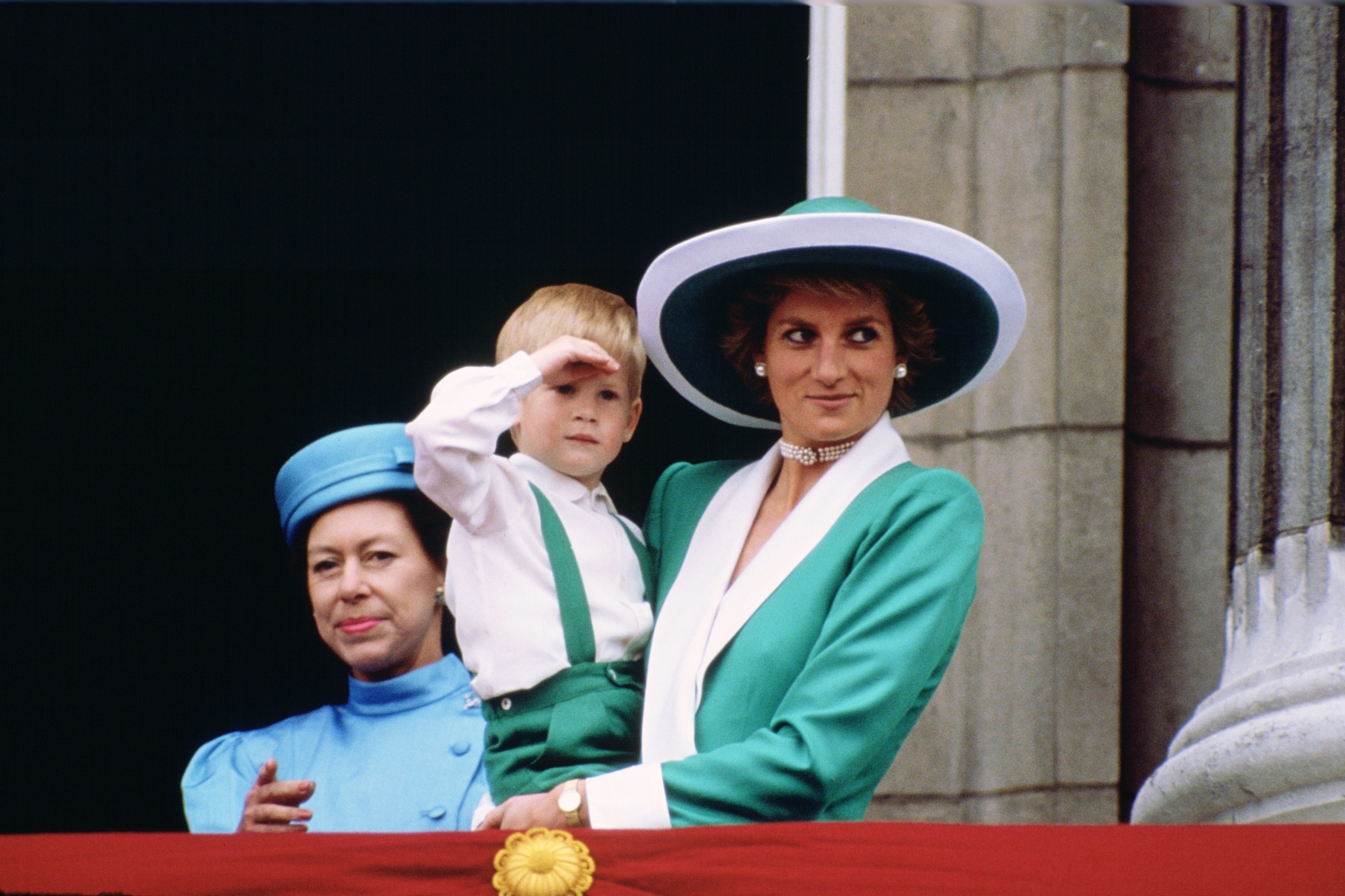 A very young Harry being held by Princess Diana