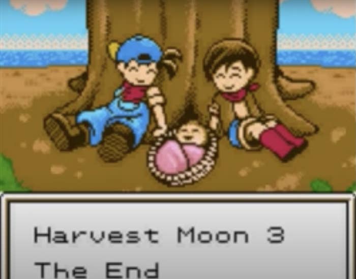 A couple with their baby sit by a tree and the game&#x27;s caption says &quot;Harvest Moon 3 The End&quot;