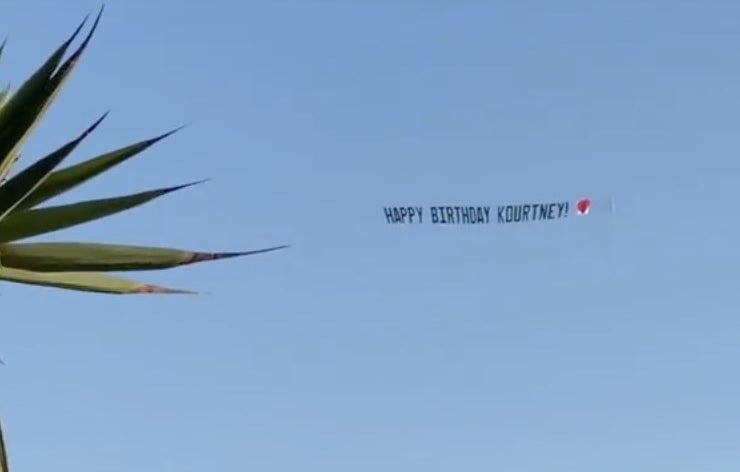 A banner flies through the sky that says, "Happy Birthday Kourtney"