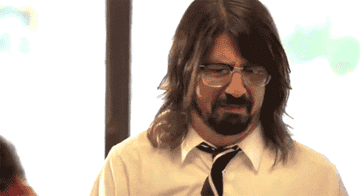 GIF of Dave Grohl dressed angrily grabbing his fast food