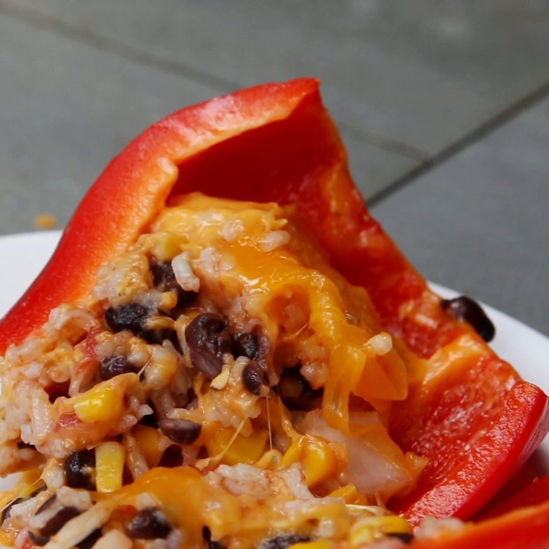 A pepper stuffed with rice, beans, corn, and cheese.