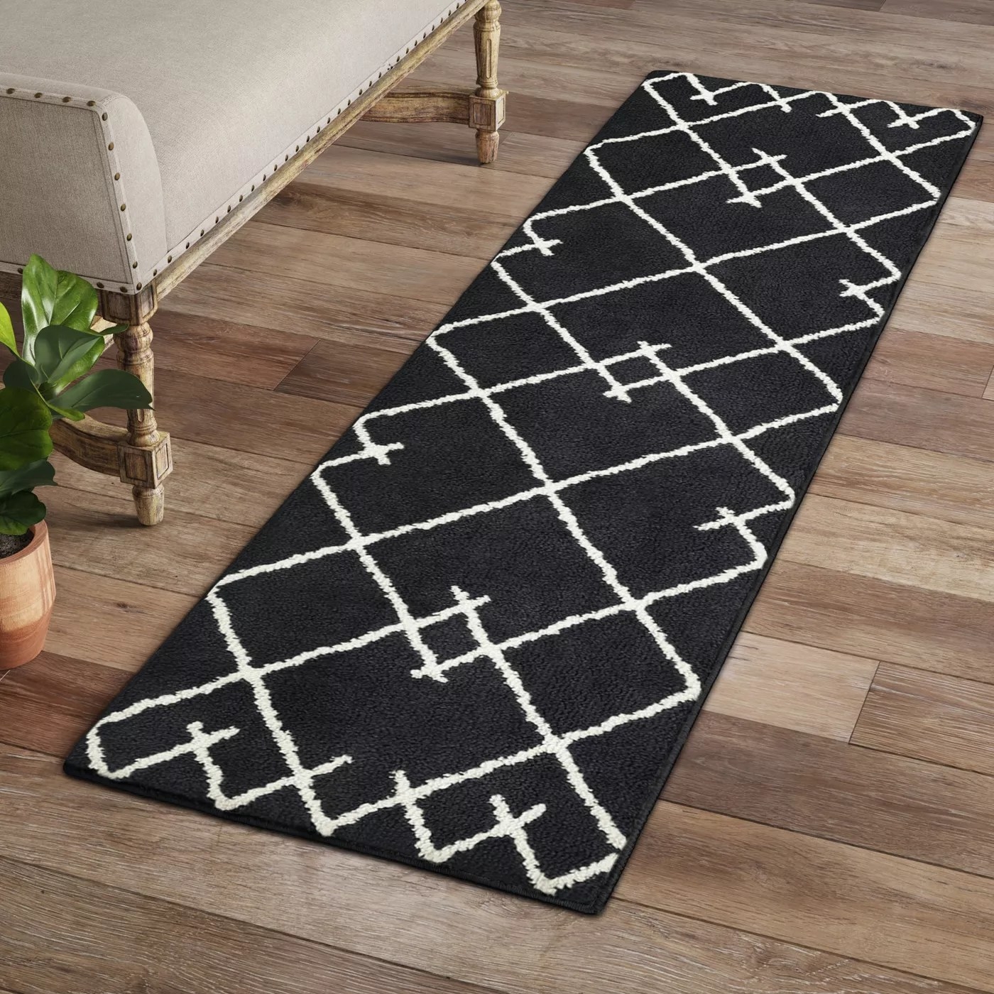 The black and white runner with a geometric pattern in an entryway