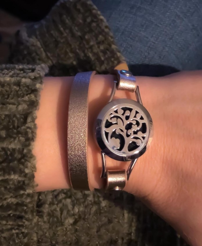 A reviewer wearing the bracelet with the rose gold band 