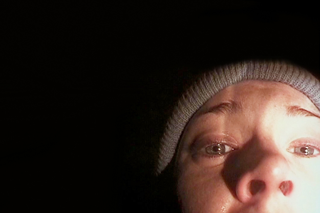 a girl cowering in the dark, hiding from a monster