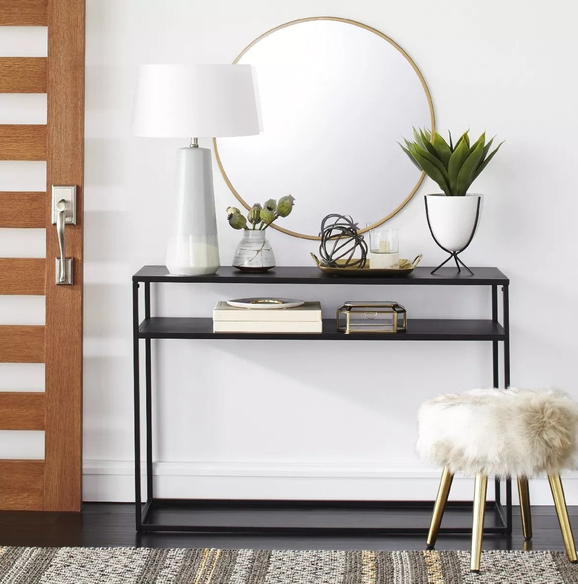 The narrow metal console with two open shelves in an entryway