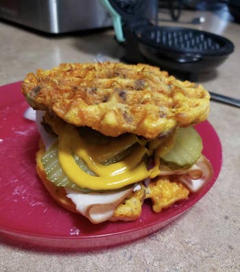 Reviewer image of cheese waffles on a burger 