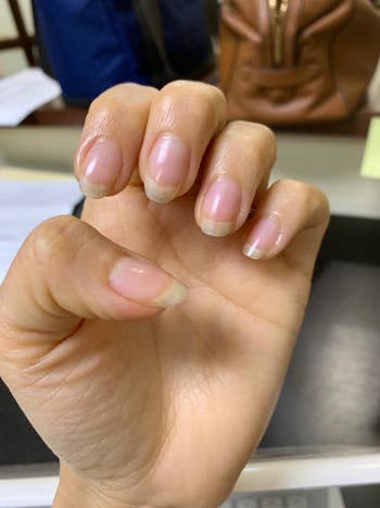 reviewer's after pic of their nails looking much longer 