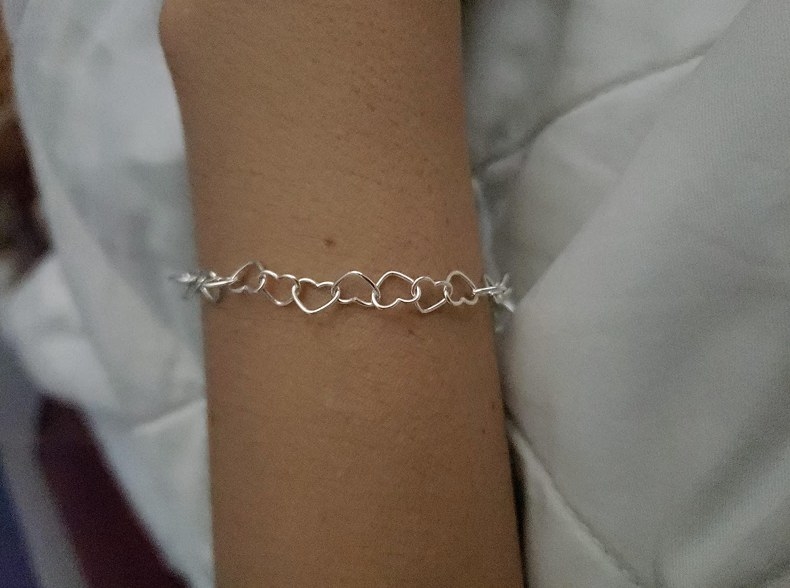 A reviewer showing themselves wearing the bracelet 