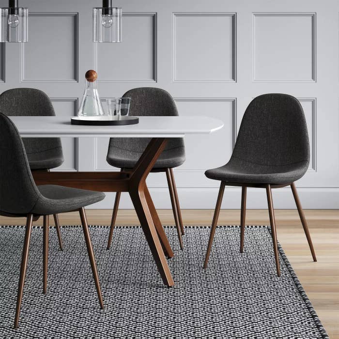 The upholstered chairs with wooden legs in a dining room