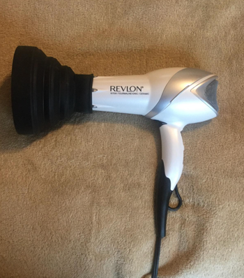 The black attachment on a hairdryer 