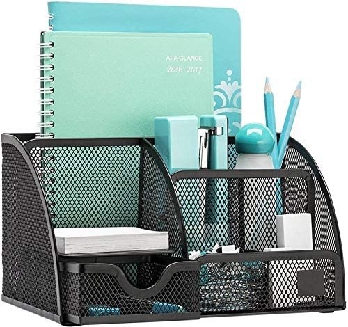 A wire mesh desk organiser with items in it 