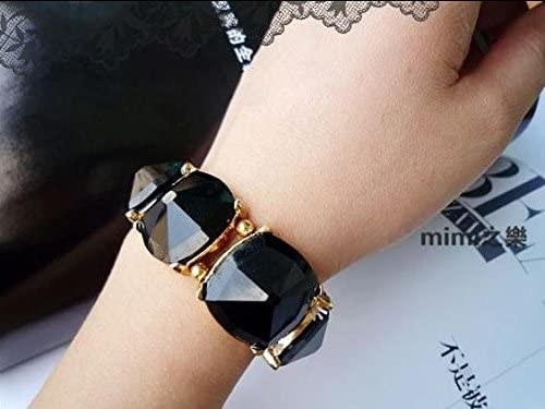 The bracelet is made with large black stones