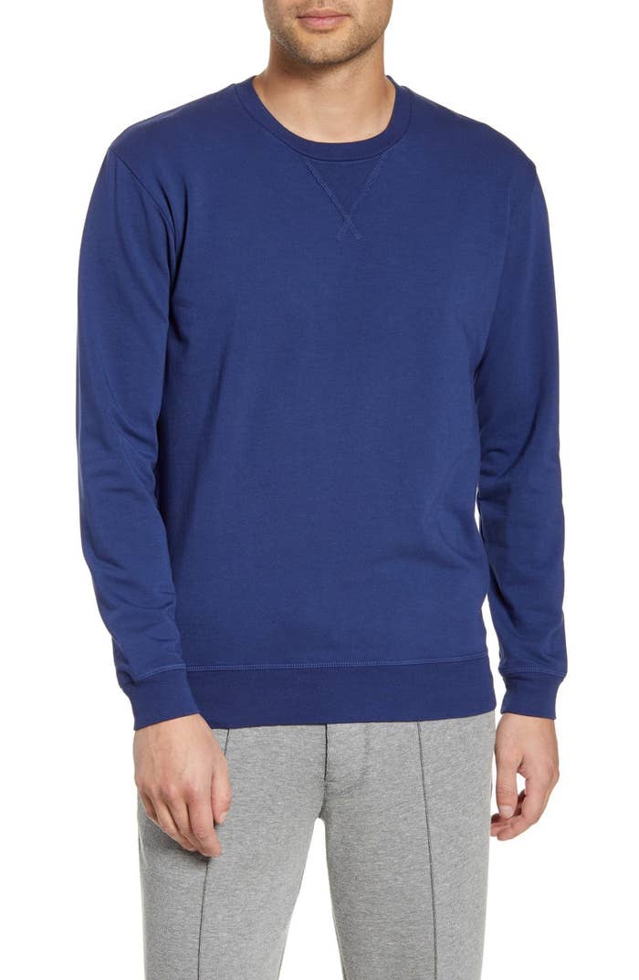 Model wearing crewneck sweatshirt in blue