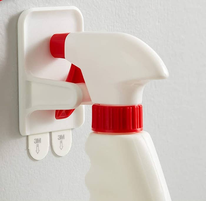 A spray bottle hanging securely from the spray bottle hanger 