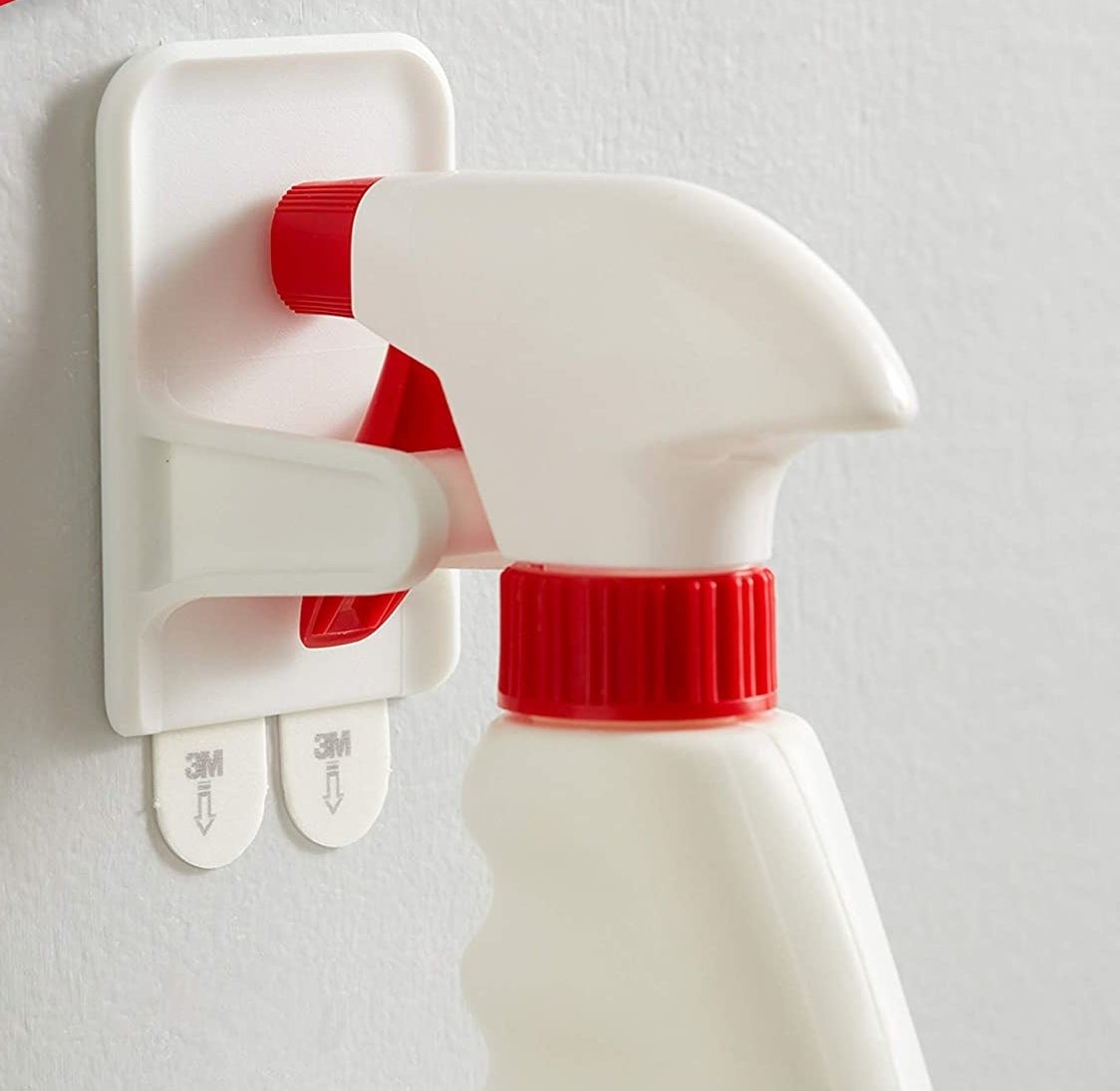 A spray bottle hanging securely from the spray bottle hanger