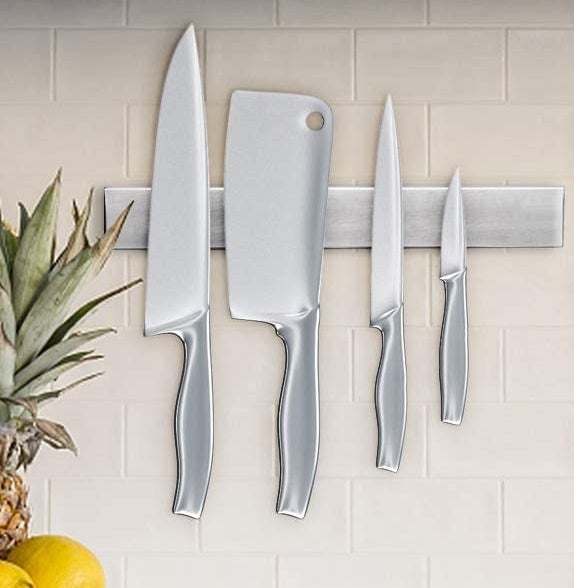 Knives hanging off of the magnetic bar 