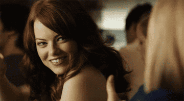 Emma Stone giving a thumbs up and a smile from a scene in Easy A 