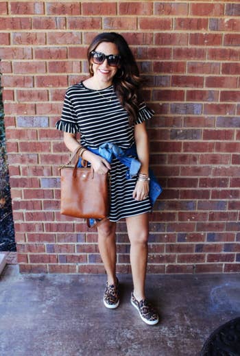 reviewer wearing the striped T-shirt dress with ruffle accents on the sleeves